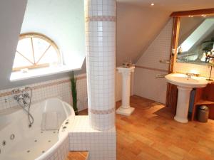 a bathroom with a bath tub and a sink at Apartment Odin-2 by Interhome in Galmsbüll