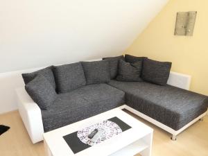 a living room with a gray couch and a table at Apartment Seestern by Interhome in Hooksiel