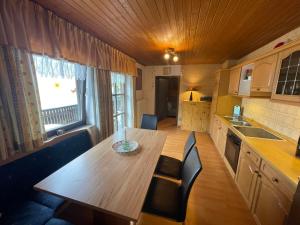 a small kitchen with a wooden table and chairs at Apartment Drexler by Interhome in Arrach