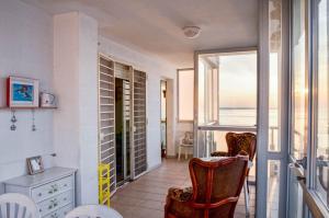 a room with a balcony with a view of the ocean at La casa al faro in Bari