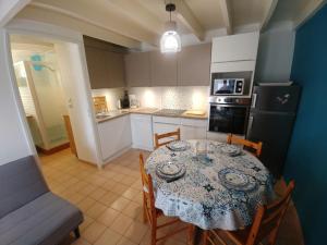 una cocina con una mesa y sillas y una cocina con una mesa y una mesa en Holiday Home Rivages d'Olonne by Interhome, en La Pironnière 12 fotos más