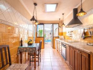 a kitchen with a table and a counter top at Holiday Home Pueblo by Interhome in Porreres