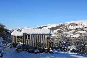 a train car with snow on top of it at Bluebell huts in Abergavenny