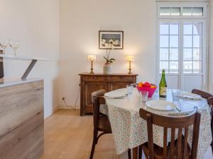 a kitchen and dining room with a table and chairs at Apartment Le Manoir du Casino by Interhome in Cabourg