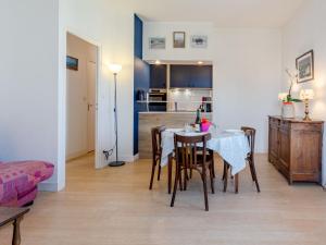 a kitchen and dining room with a table and chairs at Apartment Le Manoir du Casino by Interhome in Cabourg