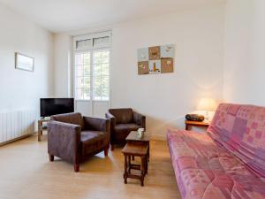 a living room with a couch and chairs and a tv at Apartment Le Manoir du Casino by Interhome in Cabourg +13 photos