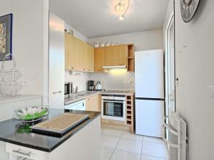 a kitchen with white appliances and a white refrigerator at Apartment Mariza by Interhome in La Baule