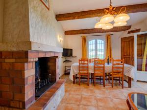 a dining room with a table and a fireplace at Apartment Bauduen by Interhome in Bauduen
