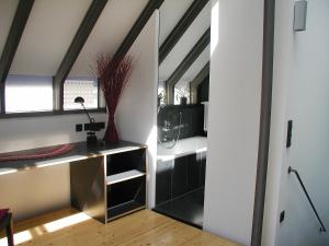 an attic room with a desk and a window at Holiday Home Albergo Centro by Interhome in Hüfingen