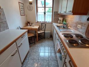 a small kitchen with a sink and a table at Apartment Alte Post-1 by Interhome in Aggsbach