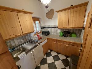 a kitchen with wooden cabinets and a sink at Apartment Alte Post-2 by Interhome in Aggsbach