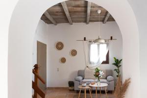 a living room with a couch and a table at Tethys by Cretan Pnoe Adults Only in Chania