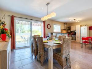 eine Küche und ein Esszimmer mit Tisch und Stühlen in der Unterkunft Holiday Home Les Ormes by Interhome in Montalivet-les-Bains