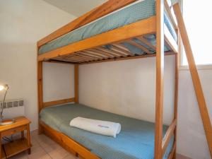 a bedroom with two bunk beds and a table at Apartment Le Panama-1 by Interhome in Saint-Aygulf