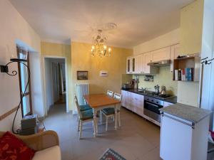 a kitchen with a table and a dining room at Apartment Cavallo - MZO102 by Interhome in Belvedere Langhe