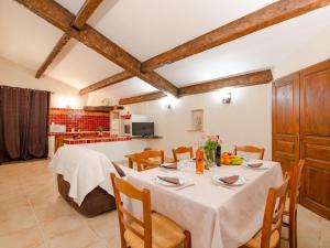 a dining room with a table and a kitchen at Apartment Laurier by Interhome in Bauduen