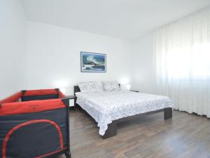a bedroom with a bed and a couch at Apartment Bozac - PUL480 by Interhome in Šikići