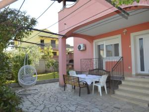 a patio with a table and chairs on a house at Apartment Bozac - PUL480 by Interhome in Šikići