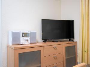 a flat screen tv sitting on top of a dresser at Apartment Strandkorb by Interhome in Norddeich