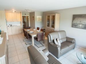 a living room with a table and a dining room at Apartment Residentie Lautrec-1 by Interhome in Bredene