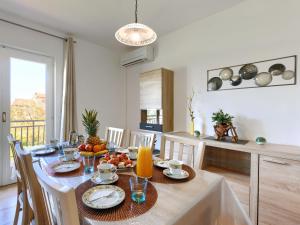a dining room with a table with fruit on it at Holiday Home Jurican - KST417 by Interhome in Višnjan