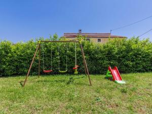 an empty swing set in a field of grass at Holiday Home Jurican - KST417 by Interhome in Višnjan