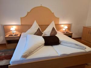 a bedroom with a bed with white pillows at Apartment Rosa-8 by Interhome in Mayrhofen