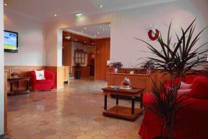 a living room with a red couch and a table at Alpine Club by Schladming-Appartements in Schladming