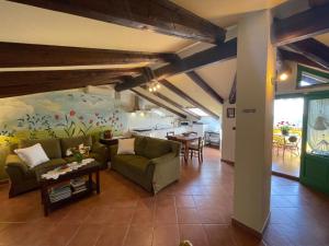 a living room with a couch and a table at Apartment Il Ghiro by Interhome in Montechiaro dʼAsti