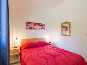 a bedroom with a red bed and a mirror at Apartment Le Thalassa 1 by Interhome in Sainte-Maxime