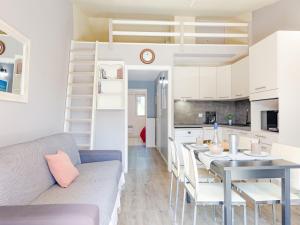a living room and kitchen with a table and a couch at Apartment Le Thalassa 1 by Interhome in Sainte-Maxime