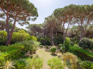 a garden with trees and bushes at Apartment Le Thalassa 1 by Interhome in Sainte-Maxime