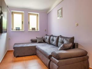 a living room with a couch and two windows at Apartment Miškulin-1 by Interhome in Senj +31 photos
