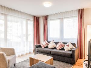 エンゲルベルクにあるApartment TITLIS Resort 2-Zimmer Wohnung 7 by Interhomeのリビングルーム(ソファ付)が備わります。一部の窓があります。