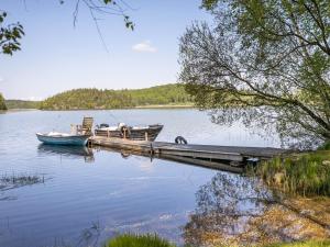 two boats are docked at a dock on a lake at Holiday Home Dammeberg - HAL033 by Interhome in Karl Gustav