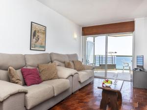 sala de estar con sofá y vistas al océano en Apartment Fanals-2 by Interhome, en Platja d'Aro