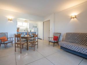 a living room with a table and chairs and a couch at Apartment Les Mouettes by Interhome in Saint-Aygulf