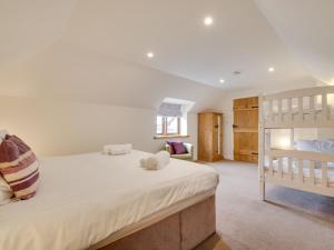 a bedroom with a bed and a bunk bed at Holiday Home Carnevas by Interhome in Saint Merryn