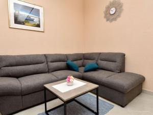 a living room with a couch and a table at Holiday Home Milka by Interhome in Anić
