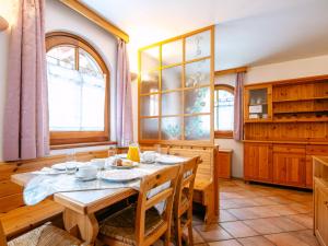 a dining room with a table and some windows at Apartment Cesa Pra da Molin-3 by Interhome in Campitello