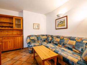 a living room with a couch and a wooden table at Apartment Cesa Pra da Molin-3 by Interhome in Campitello