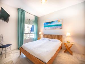 a bedroom with a large bed and a window at Apartment Lorcrimar by Interhome in Marbella