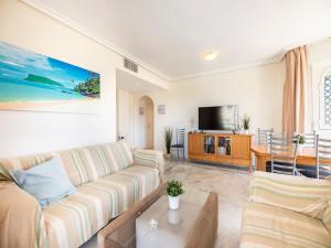 a living room with a couch and a tv at Apartment Lorcrimar by Interhome in Marbella