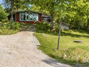 a house with a street sign in front of it at Holiday Home Ängasjö Ekbacken by Interhome in Östra Frölunda