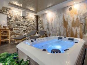 a jacuzzi tub in a room with a stone wall at Holiday Home Panorama 2 by Interhome in Labin
