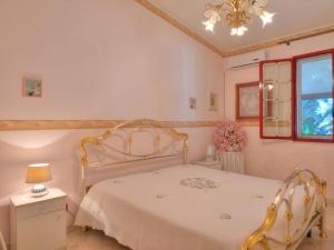 a bedroom with a white bed and a window at Villa Marianna by Interhome in Solarino