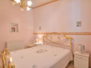 a bedroom with a bed and a chandelier at Villa Marianna by Interhome in Solarino