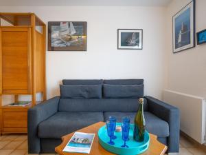a living room with a couch and a table at Apartment La Baie des Corsaires-1 by Interhome in Saint Malo
