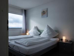 a hotel room with two beds with a window at Apartment F 96 by Interhome in Dittishausen