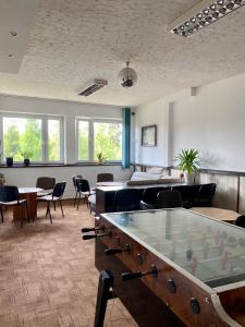 a large room with a pool table and chairs at Willa Światowid in Rabka-Zdrój